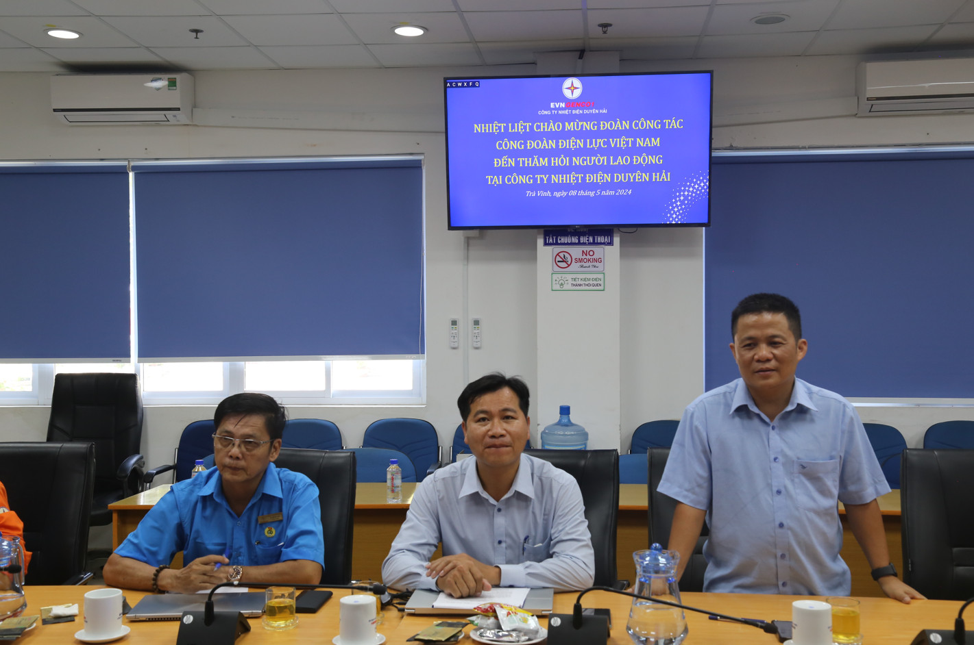 A group of men sitting at a tableDescription automatically generated